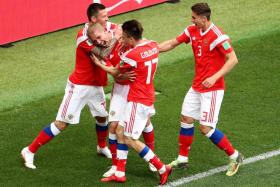 Russia&#039;s Yury Gazinsky (second from left) celebrates with teammates after scoring the opening goal of the 2018 World Cup in their game against Saudi Arabia. 