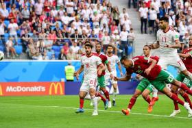 Morocco&#039;s Aziz Bouhaddouz heading the ball into his own net while trying to clear an Iran cross in stoppage time.
