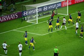 Toni Kroos (bottom, No. 8) scoring the free-kick to give Germany a last-gasp victory.