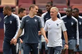 France coach Didier Deschamps (centre, right) talking to Antoine Griezmann during training.
