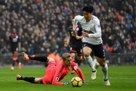 Son Heung Min (right, scoring in a match against Huddersfield in March) has become the EPL&#039;s Asia top scorer since joining from Bayer Leverkusen in 2015.