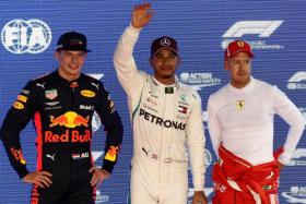 Lewis Hamilton (centre) will start on pole for the Singapore Grand Prix on Sunday, with Red Bull&#039;s Max Verstappen (left) in second spot and Ferrari&#039;s Sebastian Vettel (right) third.