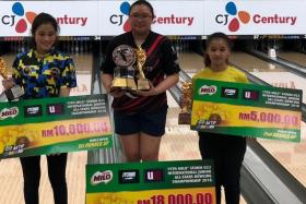 Singapore's Charmaine Chang (centre) winning the 19th Milo Storm U22 International Junior All Stars Bowling Championship in Petaling Jaya. 