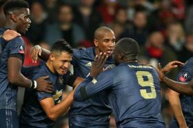 Manchester United forward Alexis Sanchez (second from left) celebrates with his teammates after scoring against his former club Arsenal.