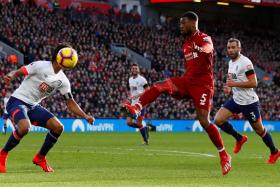 Liverpool&#039;s Georginio Wijnaldum  (in red) scoring the second goal in their 3-0 win over Bournemouth with a sublime lob. 