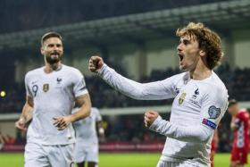 Antoine Griezmann (right) celebrates with Olivier Giroud after scoring against Moldova.