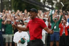 Tiger Woods letting out a roar of victory after clinching his fifth US Masters title, at the age of 43.