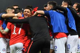 Chile&#039;s players celebrate after Alexis Sanchez converted the winning penalty.