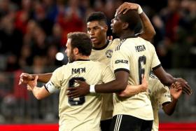 Manchester United&#039;s Marcus Rashford being congratulated by Juan Mata and Paul Pogba after opening accounts against Perth Glory.