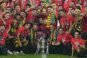 Coach Aidil Sharin (second row, centre, with scarf) celebrating with the Kedah squad after their win over Perak in the Malaysian FA Cup.
