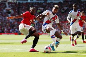 Crystal Palace&#039;s Patrick van Aanholt vying for the ball with Manchester United&#039;s Aaron Wan-Bissaka.