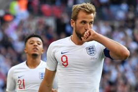 Harry Kane celebrates after completing his hat-trick with a penalty, making it 4-0 for England.