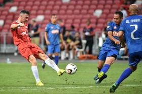 Liverpool Reds&#039; Luis Garcia attempting a shot against the Singapore Reds.