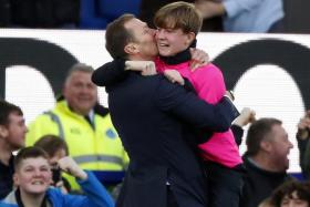 Everton&#039;s interim manager Duncan Ferguson giving a ball-boy a hug after their 3-1 win over Chelsea.
