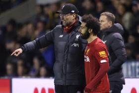 Liverpool manager Juergen Klopp giving instructions to Mohamed Salah, who was coming on as a substitute.