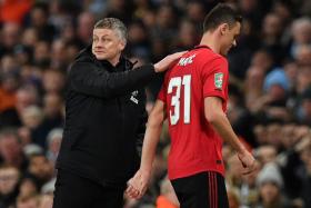 Manchester United manager Ole Gunnar Solskjaer consoling Nemanja Matic who was sent off in the second half.