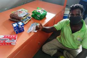 Soman Raja, 38, a worker from 53 Sungei Kadut Loop dormitory, with the essential items received from OCBC Bank on April 27.