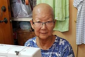 Showing grit, two elderly volunteers sew masks for those in need