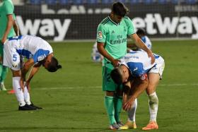 Real Madrid midfielder Marco Asensio comforting Leganes defender Unai Bustinza after their match ended in a 2-2 draw that consigned Leganes to the Segunda.