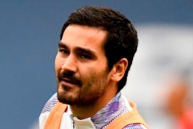 Midfielder Ilkay Guendogan (above) becomes the third Manchester City player to contract Covid-19, after winger Riyad Mahrez and defender Aymeric Laporte previously tested positive earlier this month.