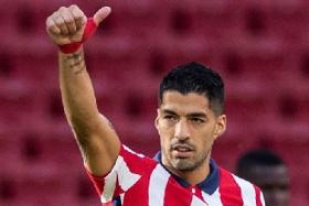 Striker Luis Suarez, who moved to Atletico Madrid from Barcelona only on Friday, started on the bench against Granada on Sunday.