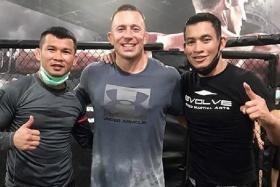 MMA legend Georges St-Pierre (centre) training at Evolve MMA Gym with ONE Championship’s bantamweight muay thai world champion Nong-O Gaiyanghadao (left) and instructor Yodkunsup Por Pongsawang.