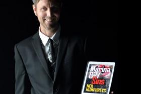 The New Paper columnist Neil Humphreys with his first crime novel titled, Marina Bay Sins.