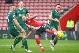Nathan Redmond (in red) scoring Southampton&#039;s third goal against Sheffield United. 