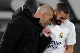 Real Madrid coach Zinedine Zidane (in black) describes Karim Benzema as phenomenal after the striker scores the opening goal and creates two others in the reigning La Liga champions&#039; 3-1 win over Eibar.  