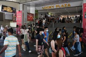 Migrant workers flock to malls after restrictions lifted