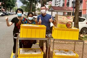 Mr Low Boon Chuan and volunteers during a delivery of fish porridge to senior activity centres and nursing homes.