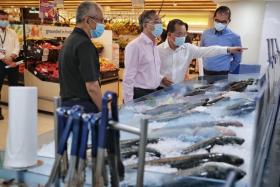 (From left) Chief executive of The Fish Farmer Malcolm Ong, Trade and Industry Minister Gan Kim Yong, FairPrice group chief executive Seah Kian Peng and FairPrice chief procurement officer Tng Ah Yiam at the locally farmed seafood section in the FairPrice outlet at Our Tampines Hub.