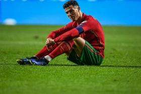 Cristiano Ronaldo cuts a frustrated figure after a late Serbia goal denies Portugal automatic qualification for Qatar 2022. 