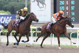 Axel (right) giving first-season apprentice jockey Jerlyn Seow her first career winner on April 24.