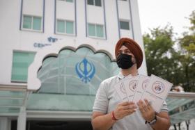 Sikh Welfare Council management committee member Sarabjeet Singh with the resource kits that address mental health concerns.