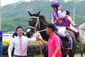 Trainer Jason Ong (far left) leading his favourite galloper, War Affair, after a race just before the pandemic struck. The 2014 Horse of the Year, who has since retired, was owned by his family. 
