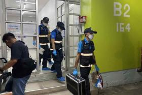 Thai police investigators at the Muang Thong condominium in Bang Phli district near Bangkok after the murder of a 23-year-old woman who lived there.