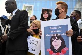 Attorney Benjamin Crump (left) speaks on December 28, 2021 outside the Los Angeles Police Department headquarters, next to Soledad Peralta and Juan Pablo Orellana Larenas, the bereaved parents of 14-year-old Valentina Orellana-Peralta who was killed by a stray police bullet last week while shopping at a clothing store.