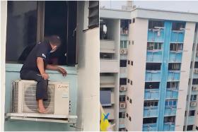 The photos posted on Facebook show the worker sitting atop an external air compressor resting on its brackets on the 11th or 12th storey. 