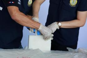 In a photo from Dec 4, 2021, Thai authorities seize packages of crystal methamphetamine in Bangkok.