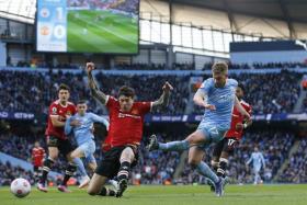 Manchester City&#039;s Kevin De Bruyne shoots at goal during the match against Manchester United, on March 6, 2022. 
