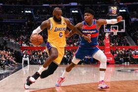 LeBron James (6) drives to the basket on Washington Wizards forward Rui Hachimura (8), on March 19, 2022. 
