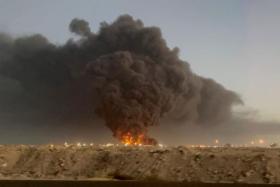 Black smoke rises after a Saudi Aramco petroleum storage facility was attacked and set ablaze in Jeddah on March 25, 2022.