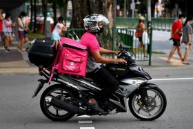 A foodpanda delivery rider delivering food on his motorbike.