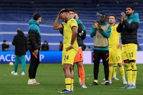 Chelsea players react at the end of the UEFA Champions League quarter final match against Real Madrid on April 12, 2022. 
