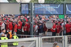 Liverpool fans stand outside prior to the UEFA Champions League final football match at the Stade de France in Paris on May 28, 2022. 