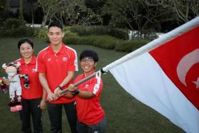 (From left) Chef de Mission for the Commonwealth Games Lim Heem Wei, badminton player Terry Hee and para-powerlifter Nur Aini Mohamad Yasli at the Team Singapore flag presentation ceremony, on July 7, 2022. 
