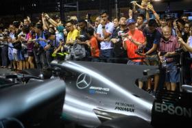 Formula One fans getting up close to watch the pit crew in action at the Mercedes AMG garage during the Thursday Pit Lane Experience ahead of the 2017 Formula One Singapore Airlines Singapore Grand Prix at the Marina Bay Street Circuit on 14 September 2017.