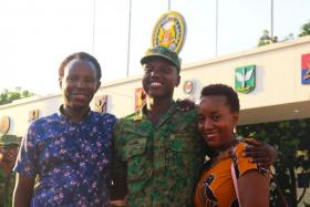 Then-Private Haniel (centre) with his parents at his BMT graduation in June 2022.