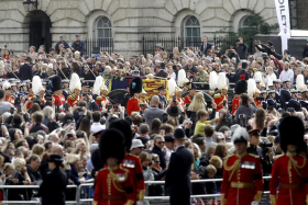 Crowds of people gather to watch the coffin of Britain&#039;s Queen Elizabeth II during the state funeral procession in London, on Sept 19, 2022. 
